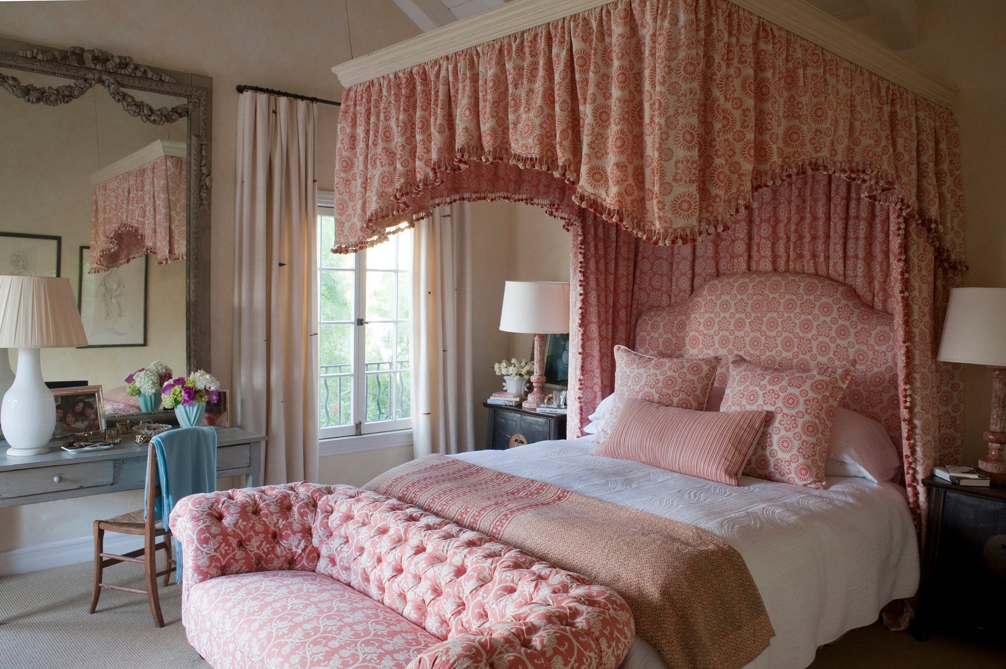 Canopy bed in Lola Rose/Coral and Pastel Pink in a Kathryn M. Ireland-designed primary bedroom