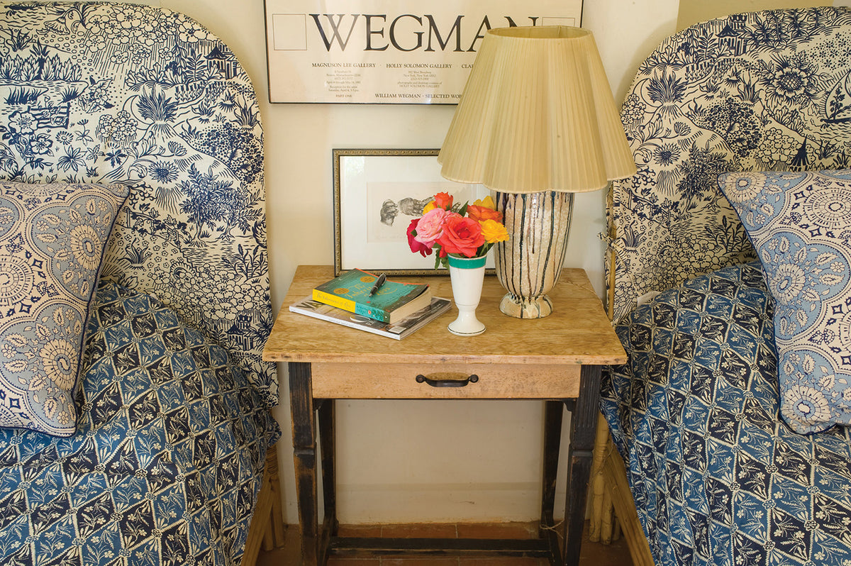 A bedroom with Diamond Batik Indigo bed spreads and Toile Blue headboards designed by Kathryn M. Ireland