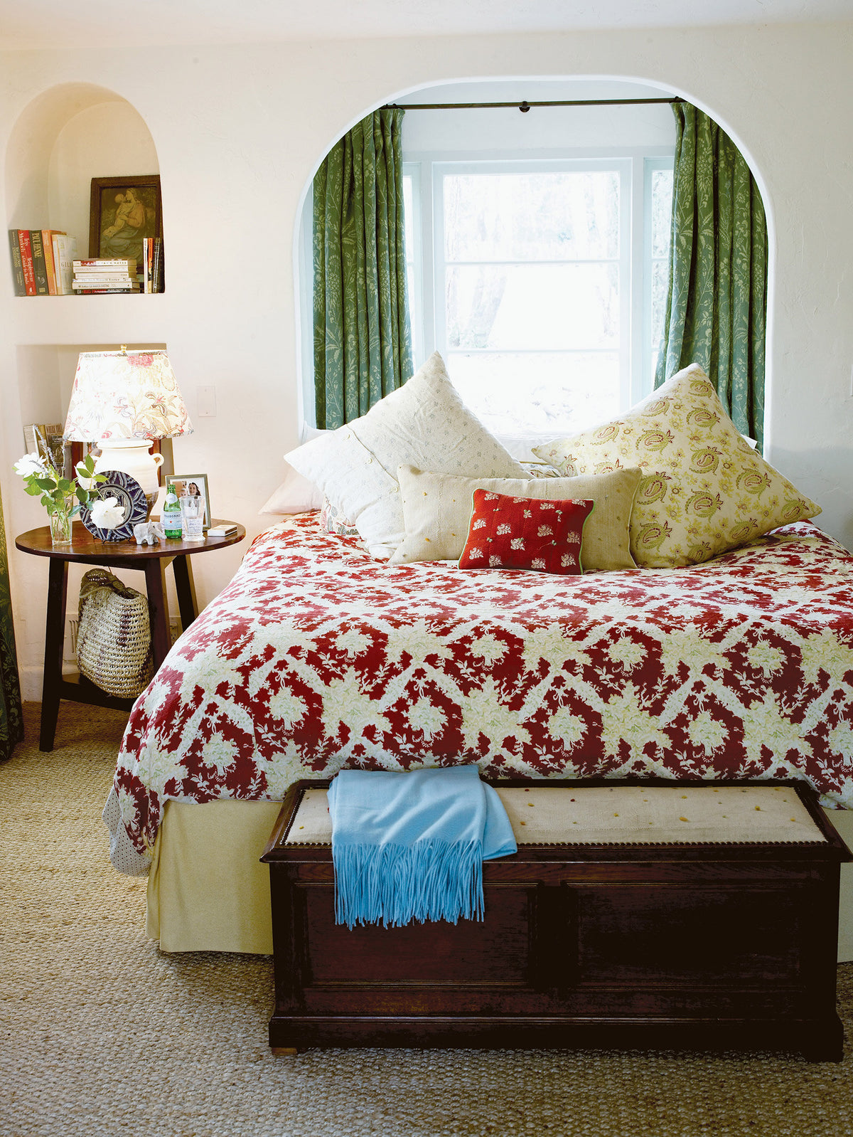 A bedroom designed by Kathryn M. Ireland featuring Ikat Red bedspread and Quilt pillow