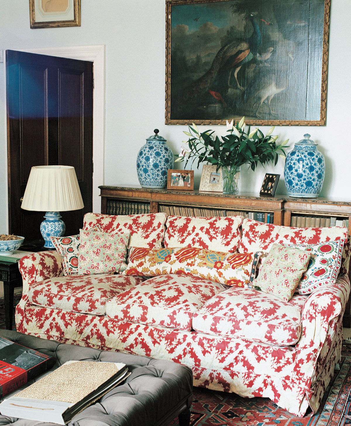 A classic slipcovered sofa in Ikat Red in a living room designed by Kathryn M. Ireland