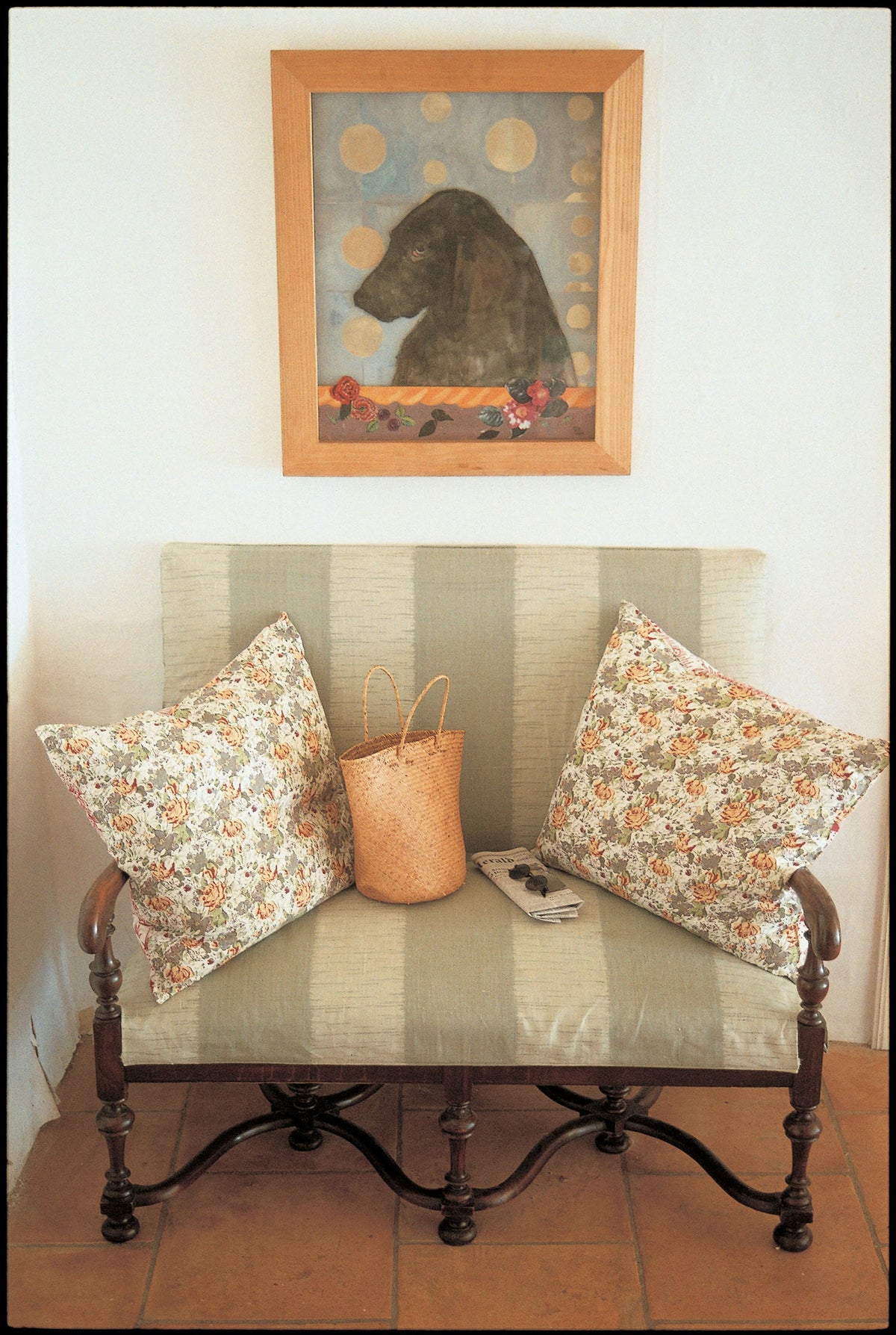 A vintage-style wooden bench with cushions in Ikat Stripe Green designed by Kathryn M. Ireland