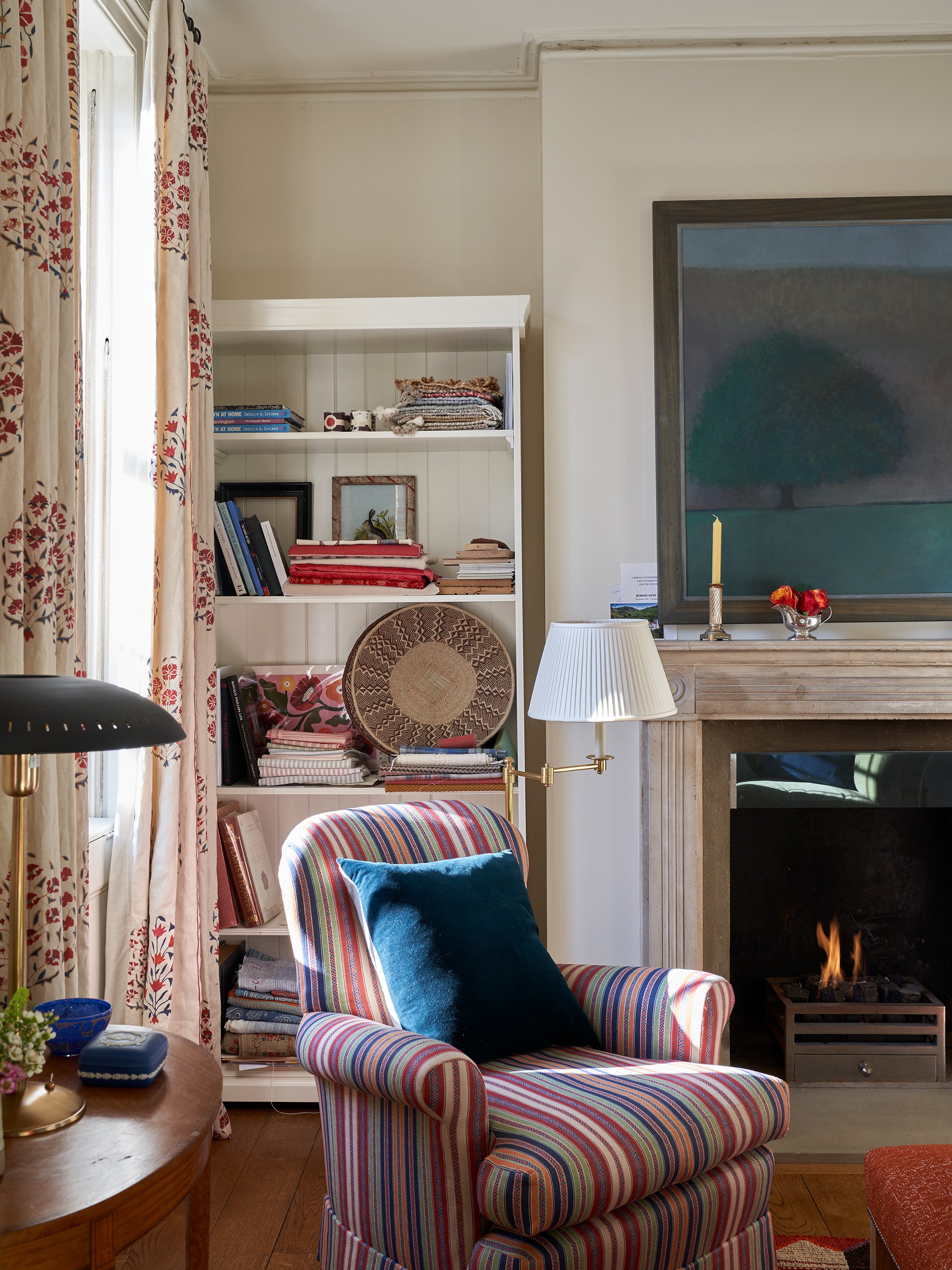 An arm chair in Ottoman Stripe Royal Multi in a living room designed by Kathryn M. Ireland