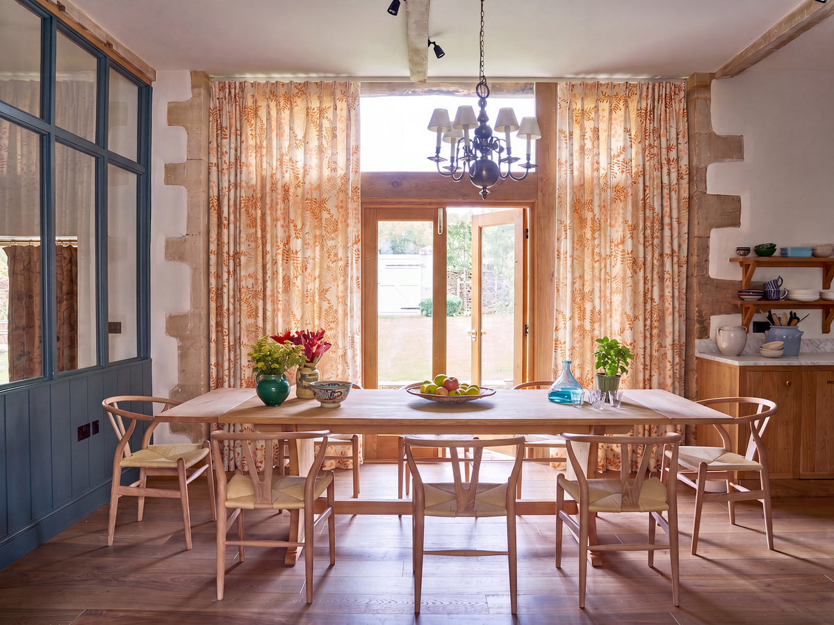 A dining room featuring Leaves Yellow curtains designed by Kathryn M. Ireland