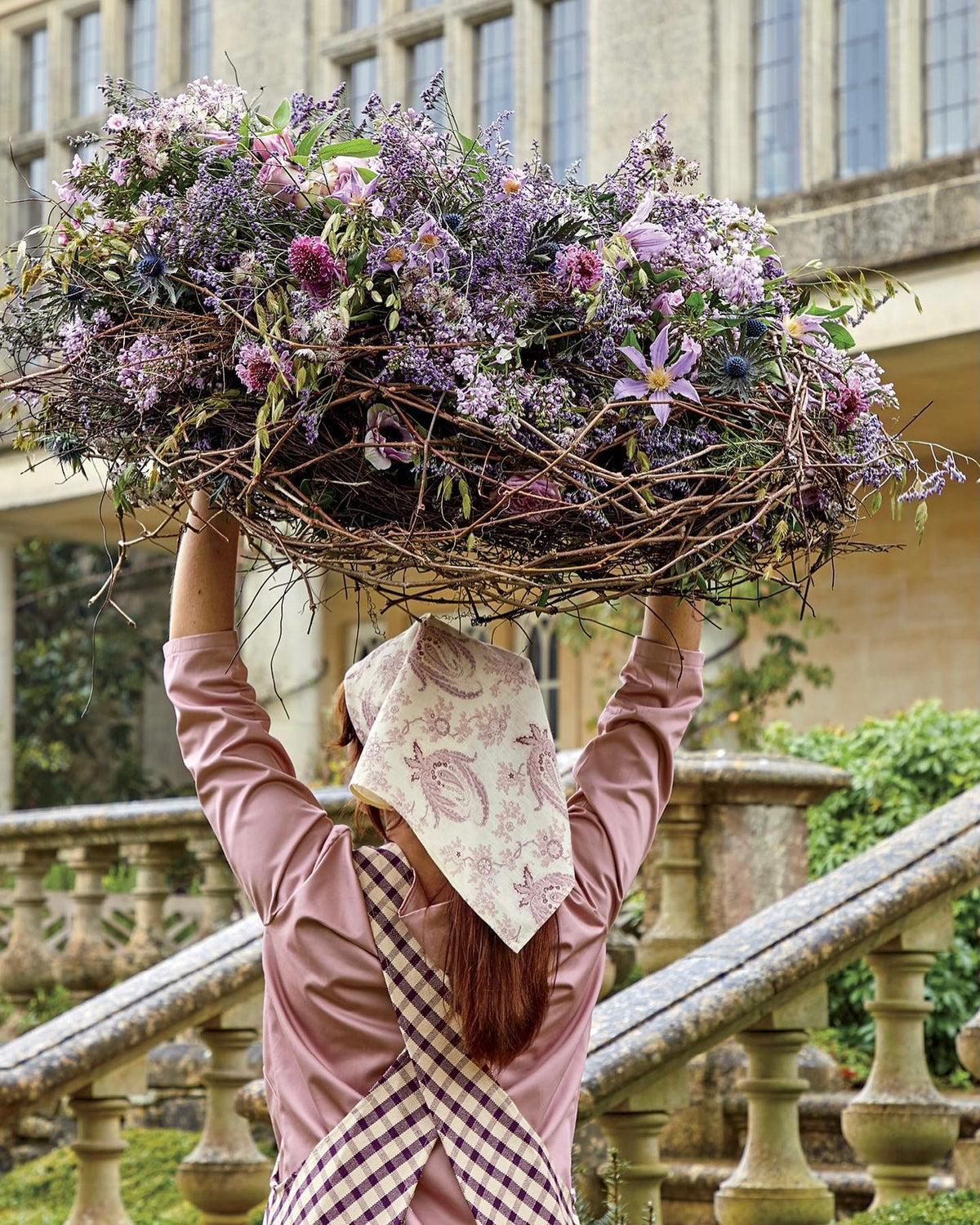 An excerpt from World of Interiors magazine featuring Paisley Stripe Lavender fabric as a head scarf, designed by Kathryn M. Ireland.