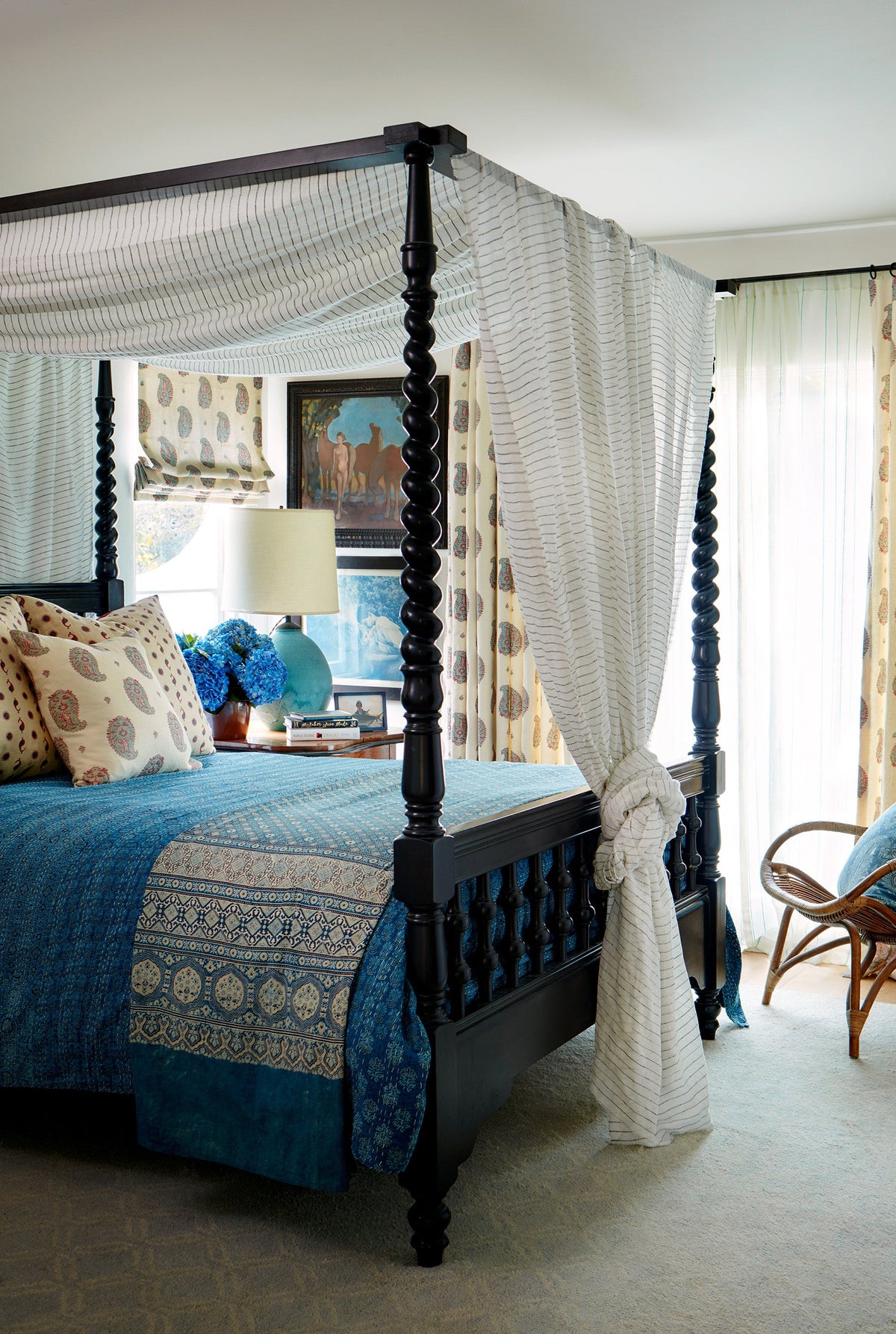 Bedroom designed by Kathryn M. Ireland with a four-poster bed, decorative pillows, and Kirkbean Red (Turquoise) curtains.
