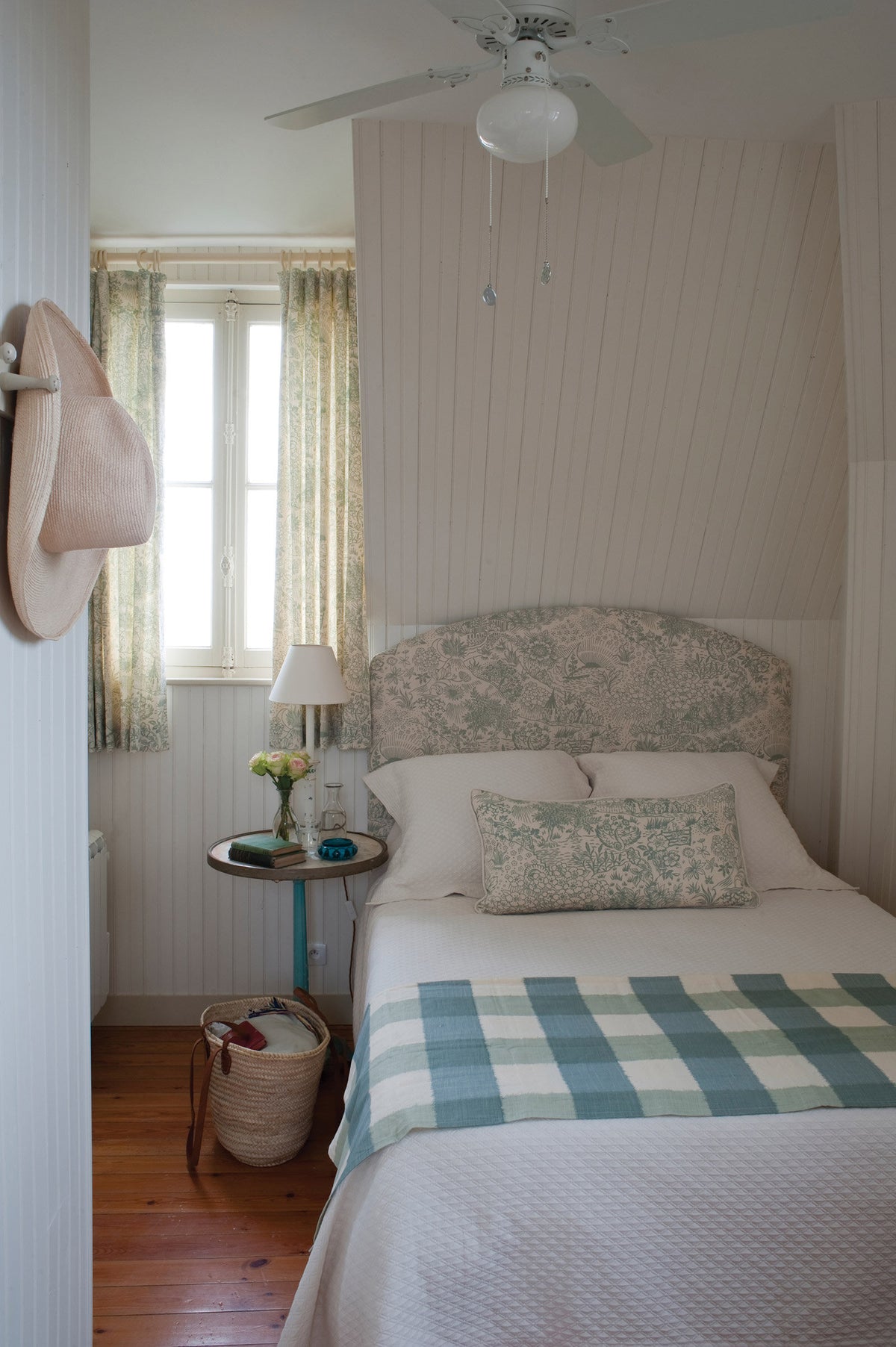 A twin bed featuring a headboard and pillow in Toile Teal designed by Kathryn M. Ireland