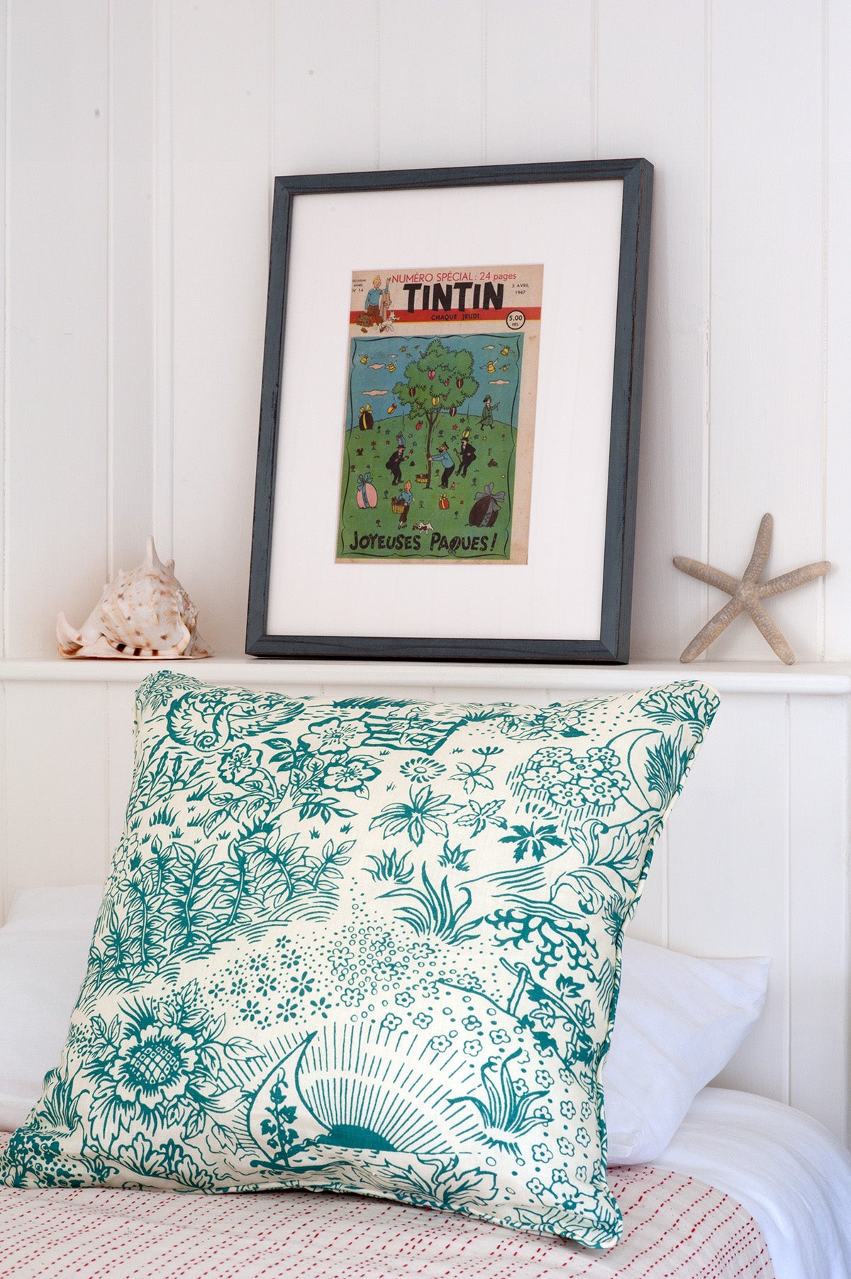 A pillow in Toile Teal on a bed spread in Hand-Stitched Red, designed by Kathryn M. Ireland