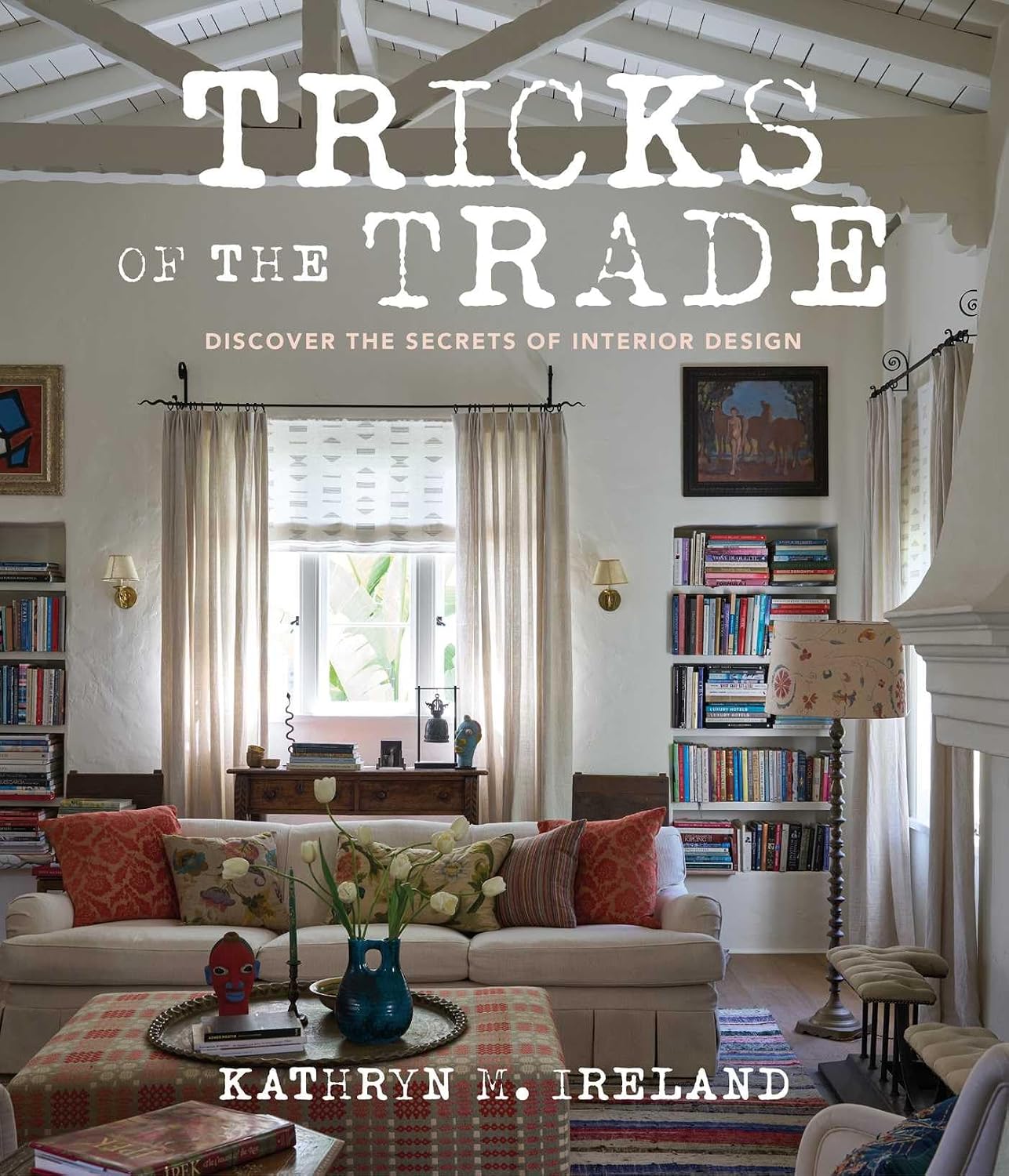 Book cover of 'Tricks of the Trade' by Kathryn M. Ireland featuring a living room with books and decor.