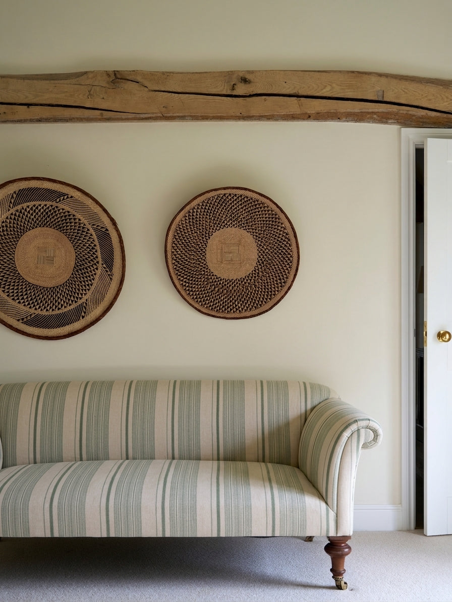 A classic upholstered sofa in Vicenza Stripe Sea by Kathryn M. Ireland